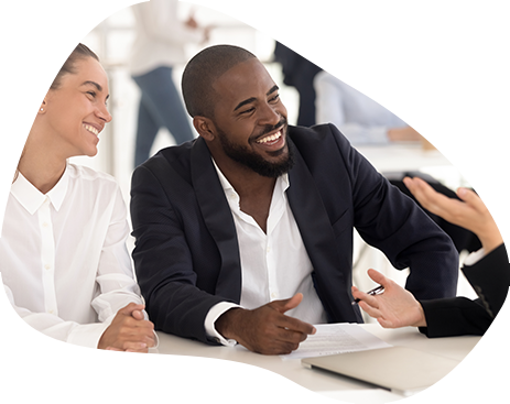 Photo of business people at a desk smiling